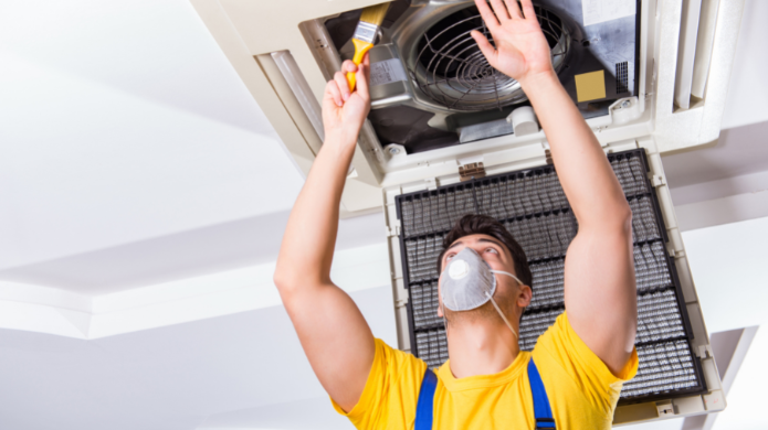 Top AC Services Dubai - Skilled HVAC technician servicing air conditioner